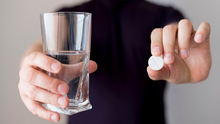 person holding glass water pill 23 2148506103